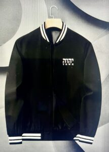 Varsity Jacket. All black trimmed in white stripes. YHWH is pictured on the left upper side of the jacket.